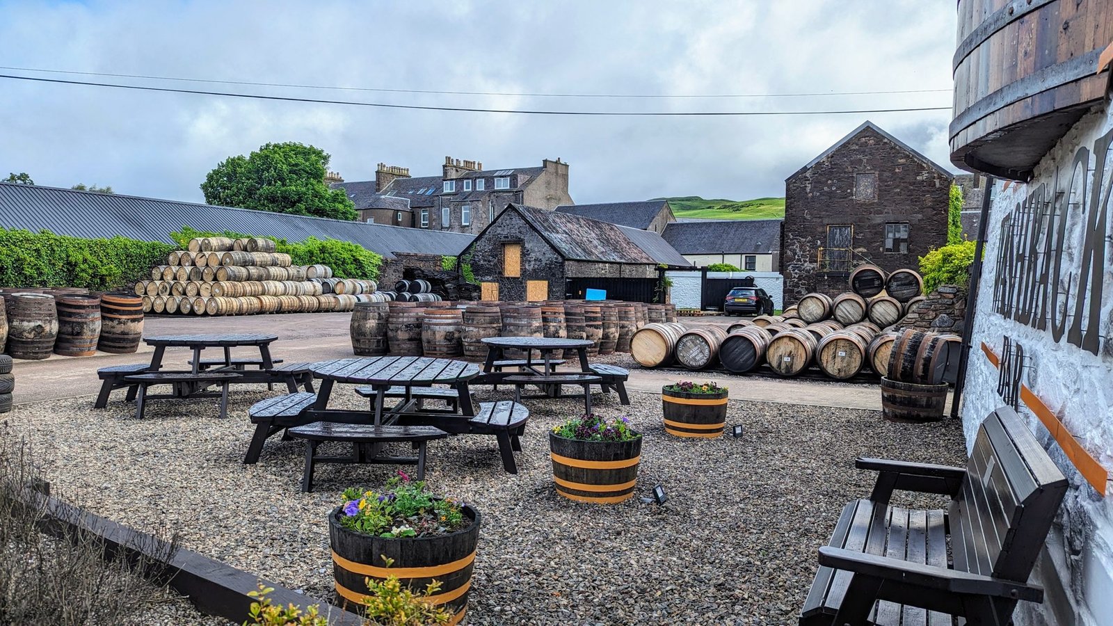 Whisky casks and picnic benches in the courtyard of Springbank distillery, Campbeltown.