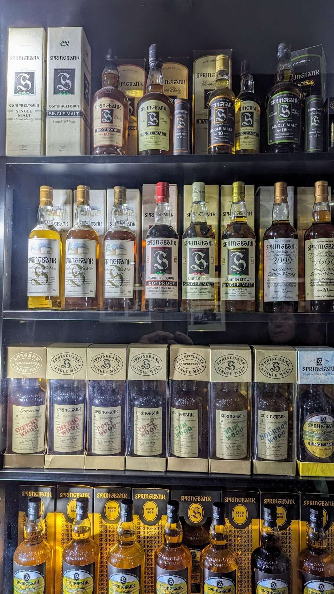 Shelves of Springbank and Cadenhead's whisky bottles in the distillery shop in Campbeltown.
