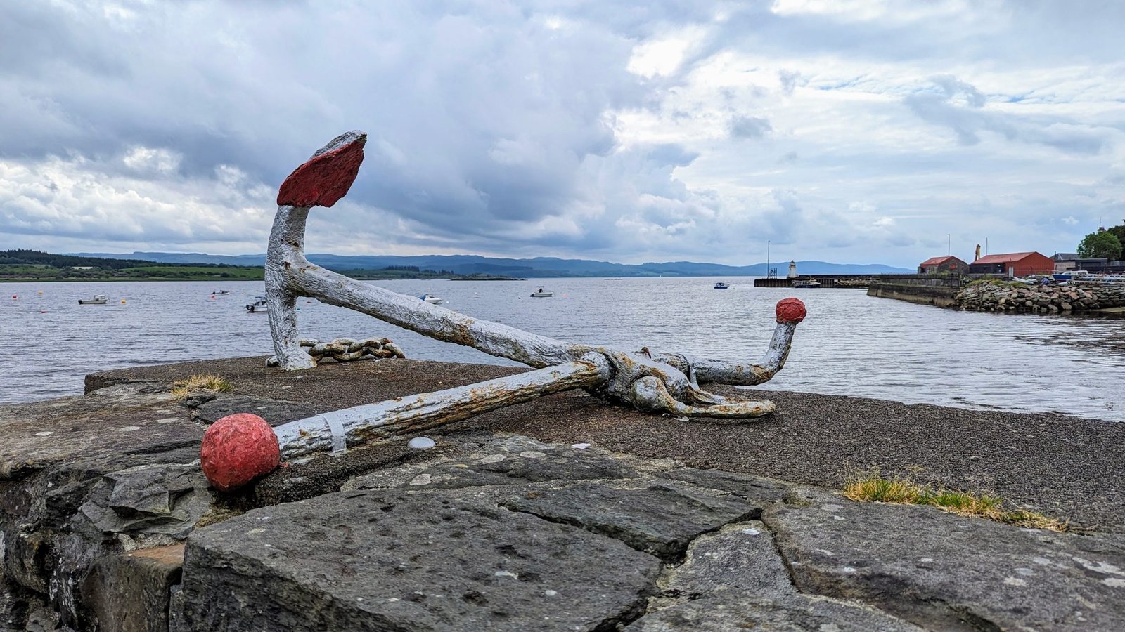 The Ardrishaig seafront on Loch Fyne with an old anchor monument on the shore.