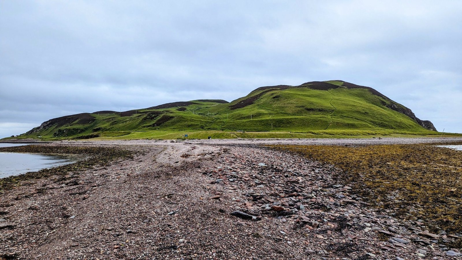 The Dhorlin — a natural shingle causeway exposed at low tide — leading across to the green hump of Davaar Island at the mouth of Campbeltown Loch.