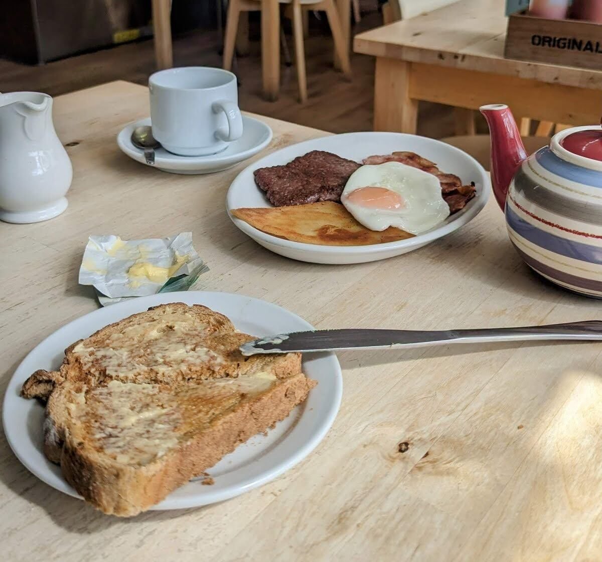 A full Scottish breakfast and coffee on a café table by Dunoon pier.