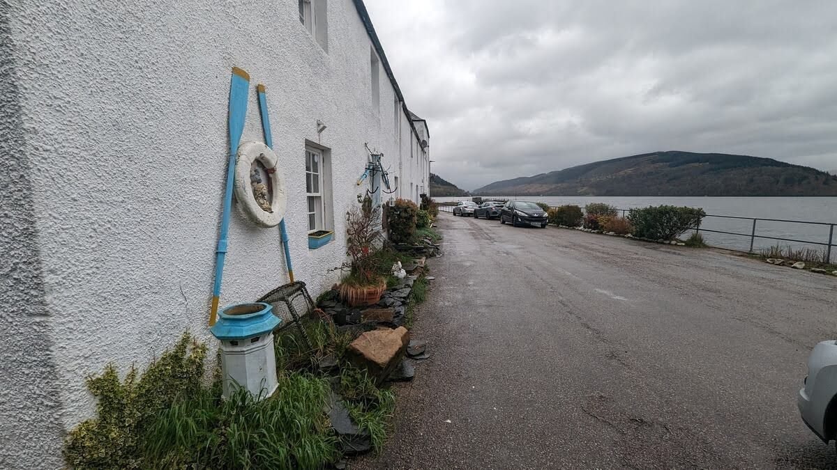 The whitewashed waterfront cottages of Inveraray on Loch Fyne, hung with lifebuoys and flower pots.