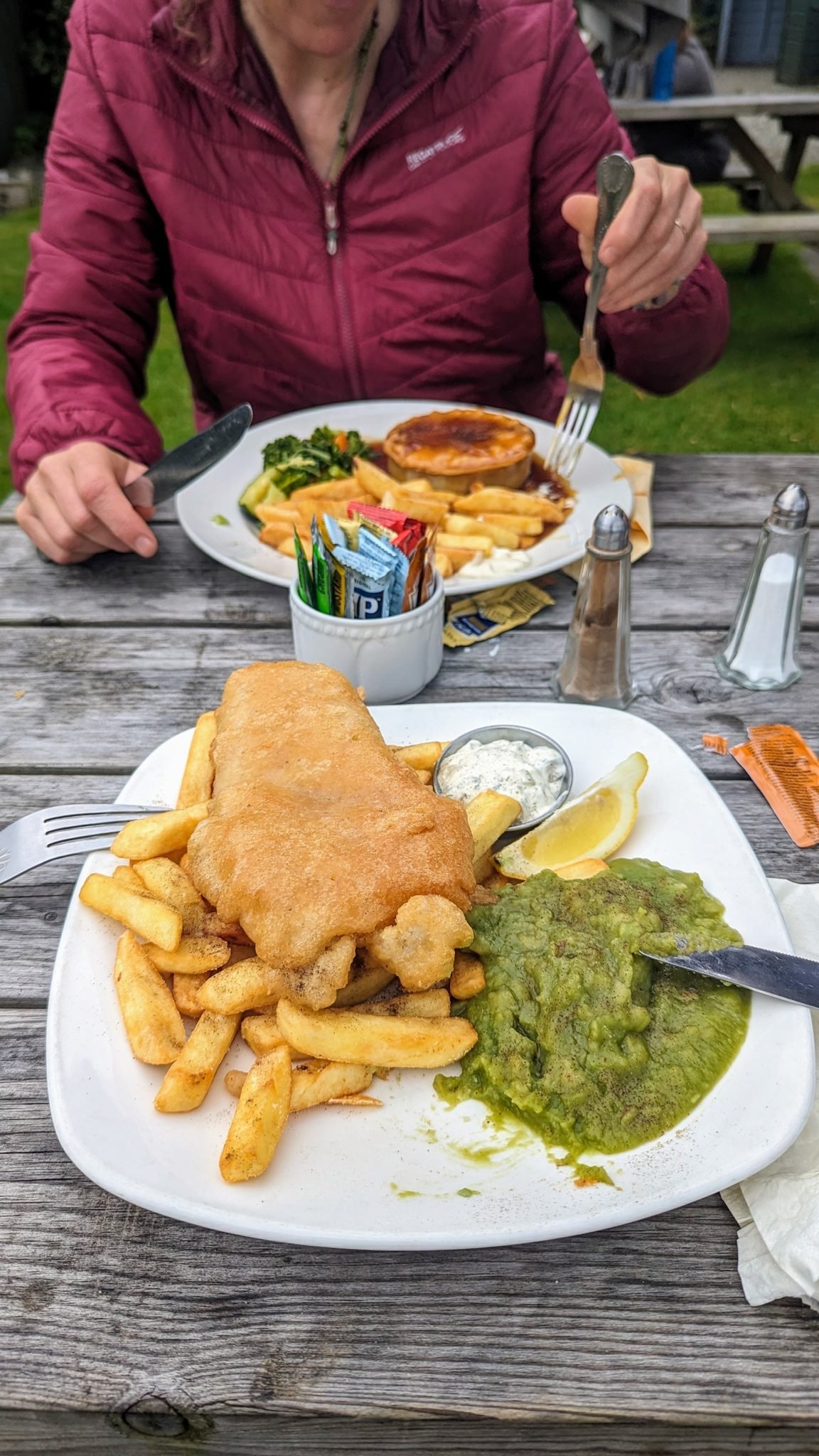 A plate of fish and chips with peas on a table at the Kilmartin Hotel.