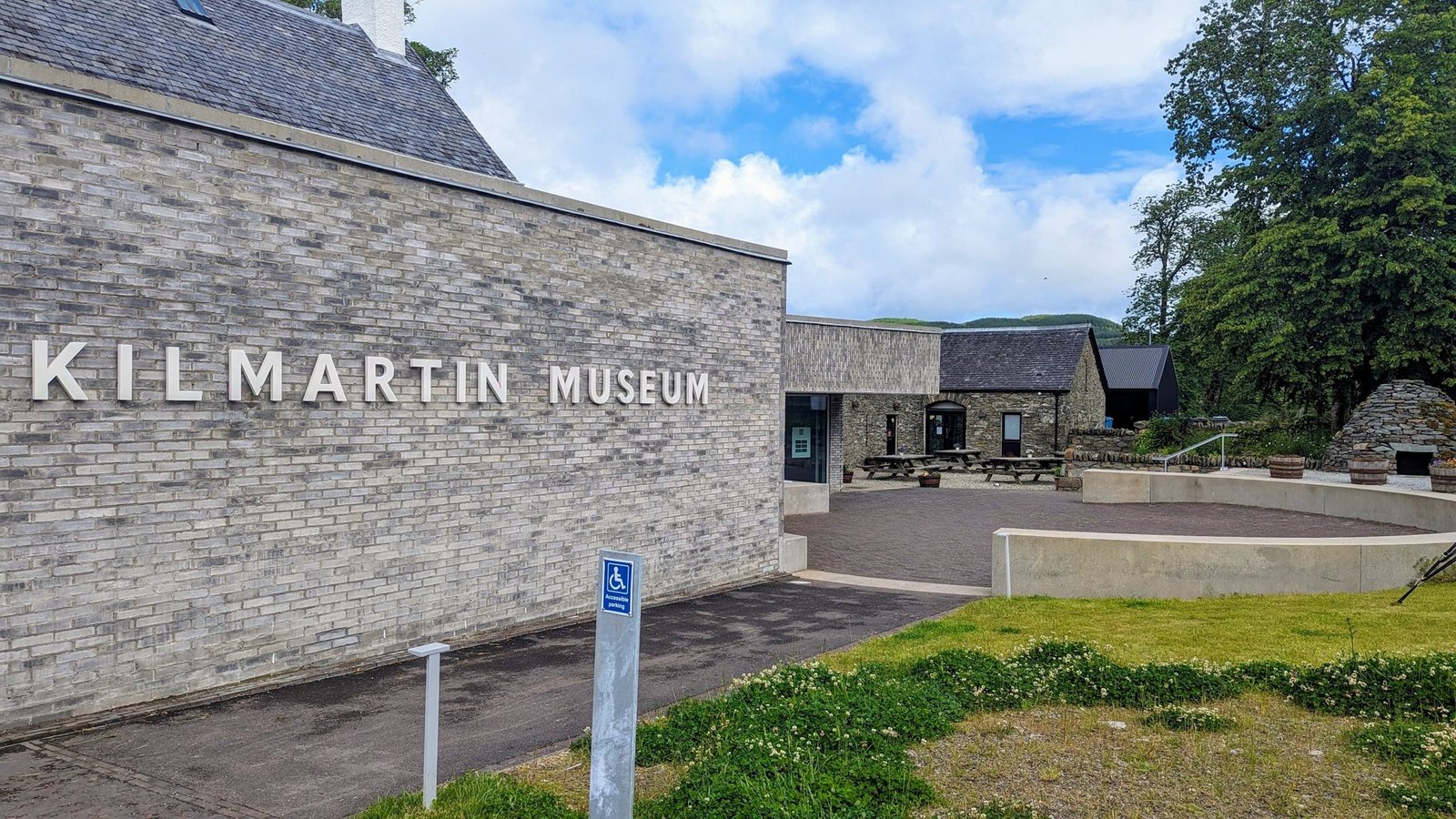 The modern stone frontage of Kilmartin Museum in the village, with its name carved on the wall.