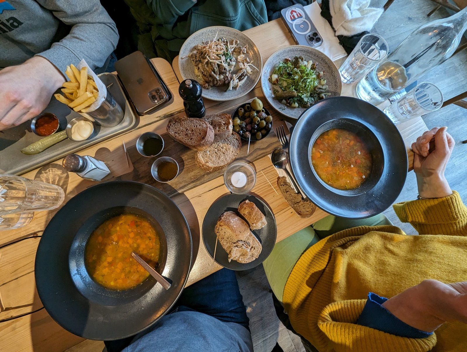 A lunch spread of soup, bread, olives and sharing plates on a wooden table at a North Berwick café.