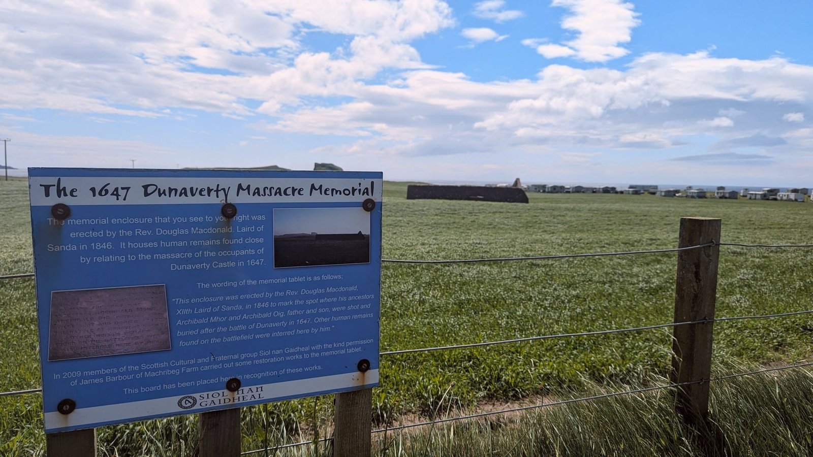 The interpretation board telling the story of the 1647 Dunaverty Massacre at Southend, Kintyre.
