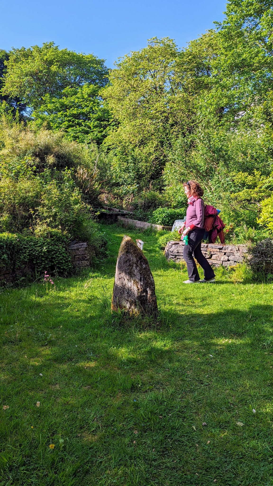 Standing stones in a grassy healing garden at the An Tairbeart heritage centre near Tarbert.
